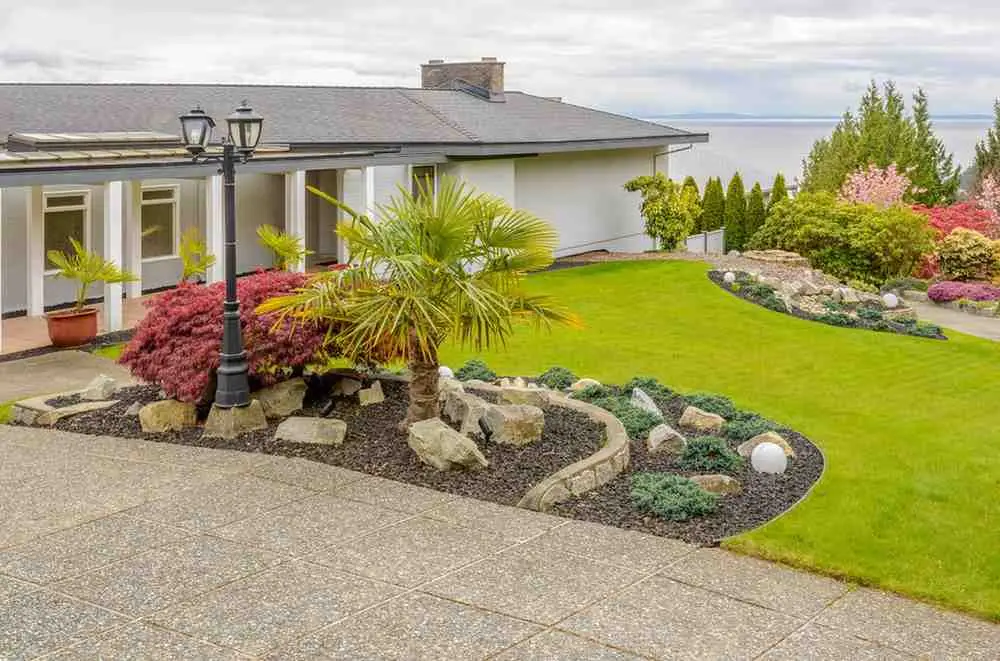 Low Maintenance Front Yard Landscaping with Rocks, Shrubs, and Green Lawn