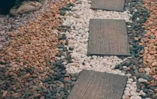 River Rock Landscaping Ideas with modern stepping stone pathway and mixed color decorative rocks
